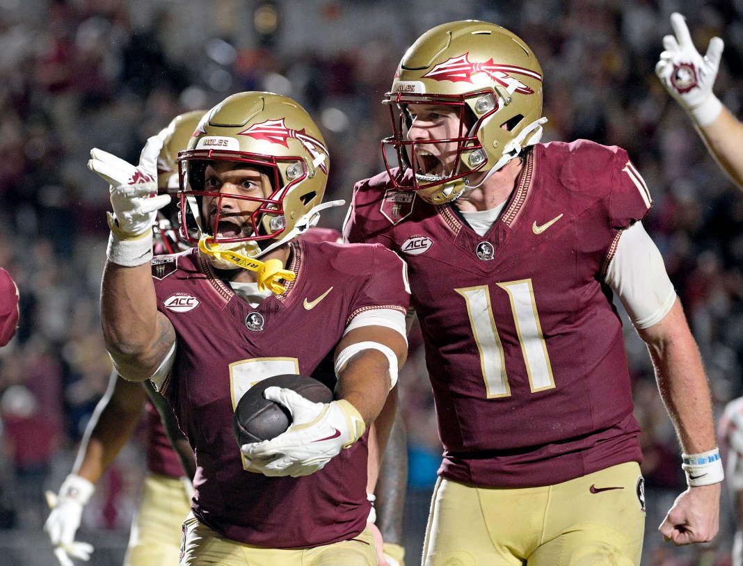 Florida State Seminoles wide receiver Ja'Khi Douglas (0) celebrates with quarterback Brock Glenn (11) after a touchdown against the Clemson Tigers