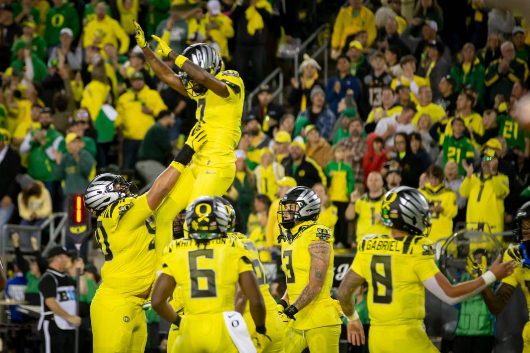 Oregon Ducks wide receiver Evan Stewart is thrown into the air after catching a touchdown reception as the Ducks host the Spartans