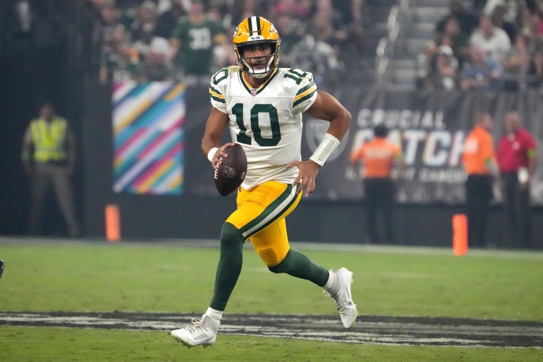 Green Bay Packers quarterback Jordan Love carries the ball