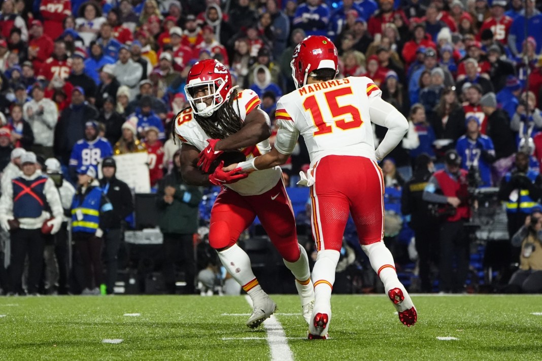 Kansas City Chiefs quarterback Patrick Mahomes hands the ball off to Kansas City Chiefs running back Kareem Hunt