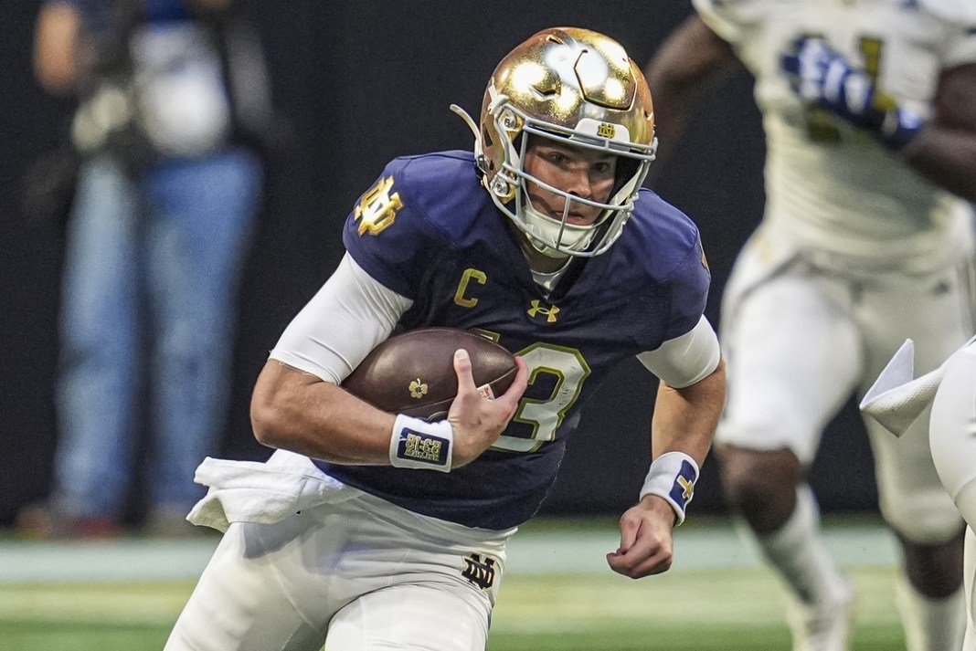 Notre Dame Fighting Irish quarterback Riley Leonard runs against the Georgia Tech Yellow Jackets at Mercedes-Benz Stadium