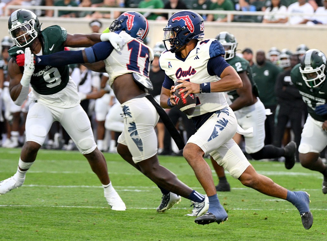 Florida Atlantic Owls quarterback Cam Fancher runs around the end in the first quarter against the Michigan State Spartans at Spartan Stadium.