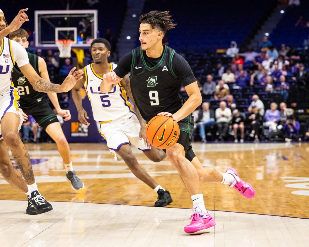 Stetson Hatters guard Blaize Sagna (9) dribbles while defended by LSU Tigers guard Cam Carter (5) during the second half at Pete Maravich Assembly Center on December 17, 2024.