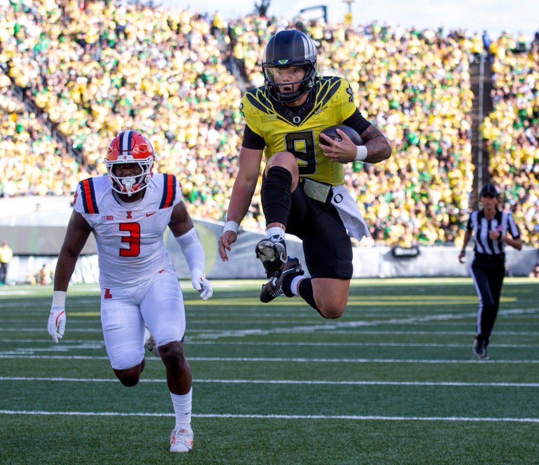 Oregon quarterback Dillon Gabriel leaps into the end zone for a touchdown during the second quarter against Illinois