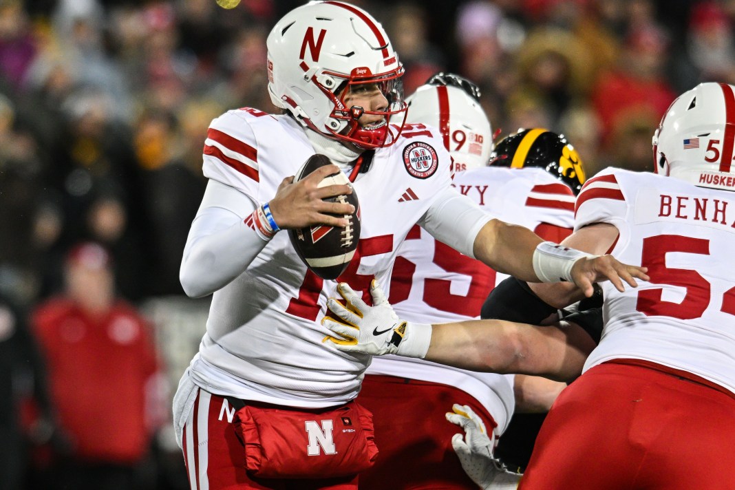 Nebraska Cornhuskers quarterback Dylan Raiola scrambles as offensive lineman Bryce Benhart blocks