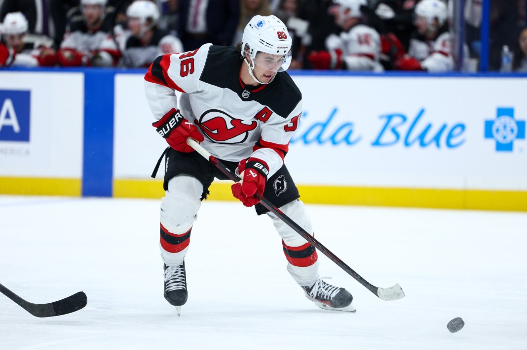 New Jersey Devils center Jack Hughes controls the puck against the Tampa Bay Lightning