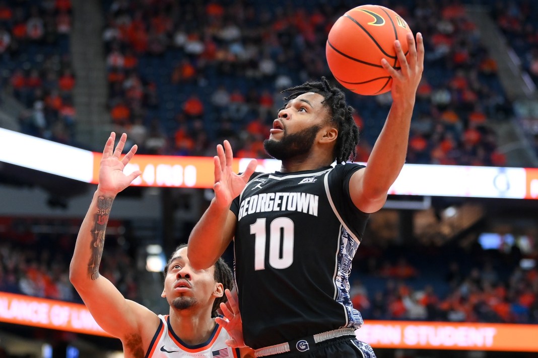 Georgetown Hoyas guard Jayden Epps (10) takes a shot while defended by Syracuse Orange guard Jaquan Carlos during the first half at JMA Wireless Dome on December 14, 2024