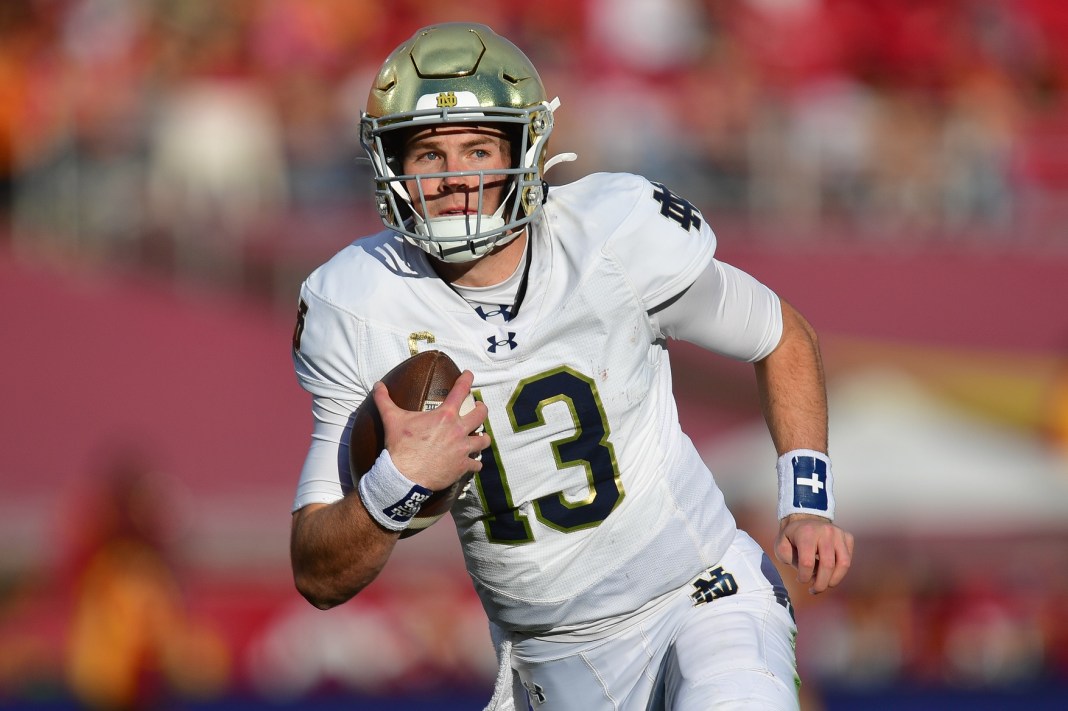 Notre Dame Fighting Irish quarterback Riley Leonard runs the ball against the Southern California Trojans