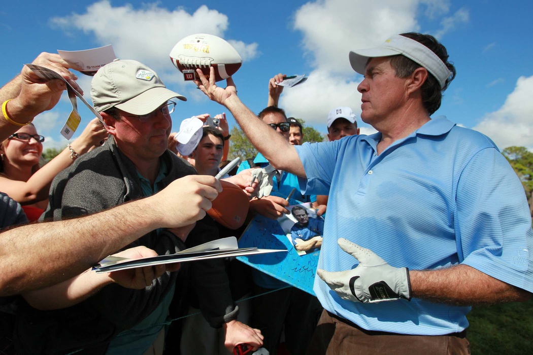 New England Patriots head coach Bill Belichick signs autographs during his pro-am appearance