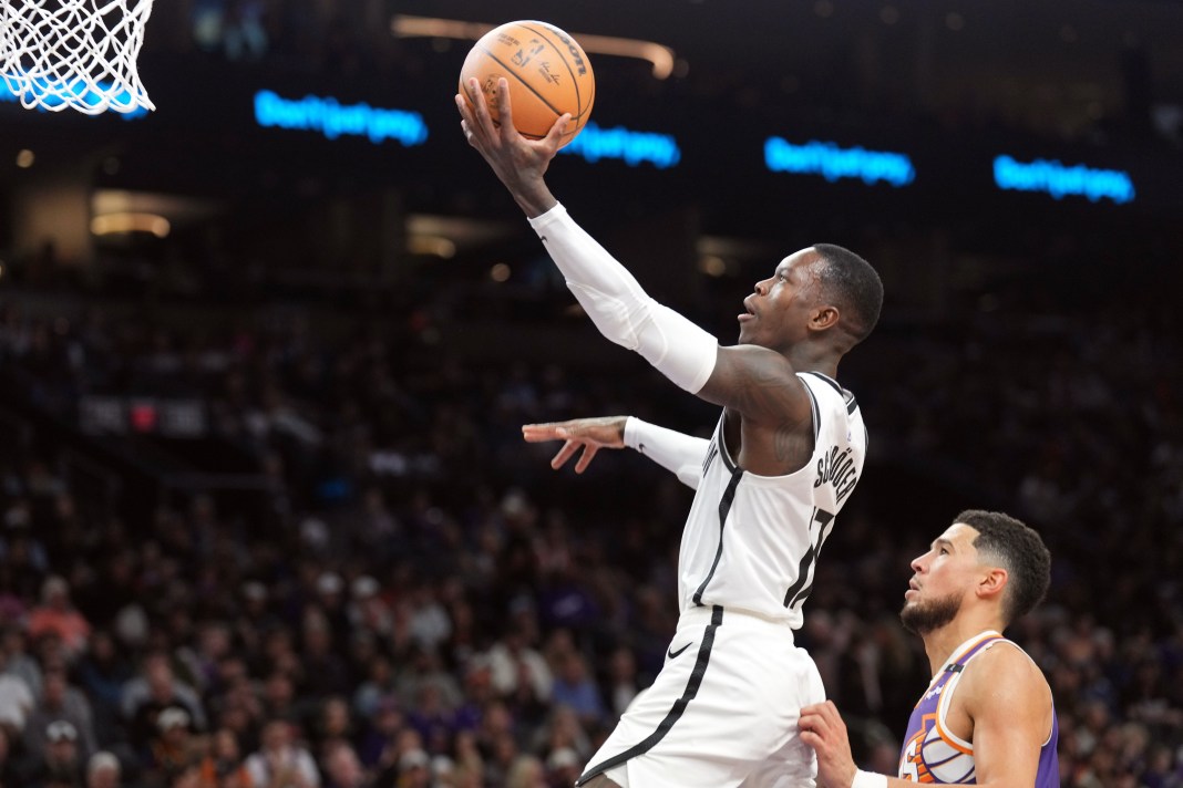 Nets guard Dennis Schroder goes for a layup against the Suns during the 2024-25 NBA season.