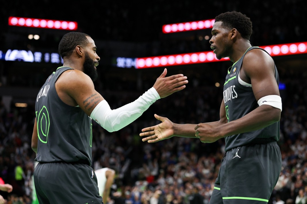 Timberwolves guards Mike Conley and Anthony Edwards celebrate a win over the Clippers during the 2024-25 NBA season.