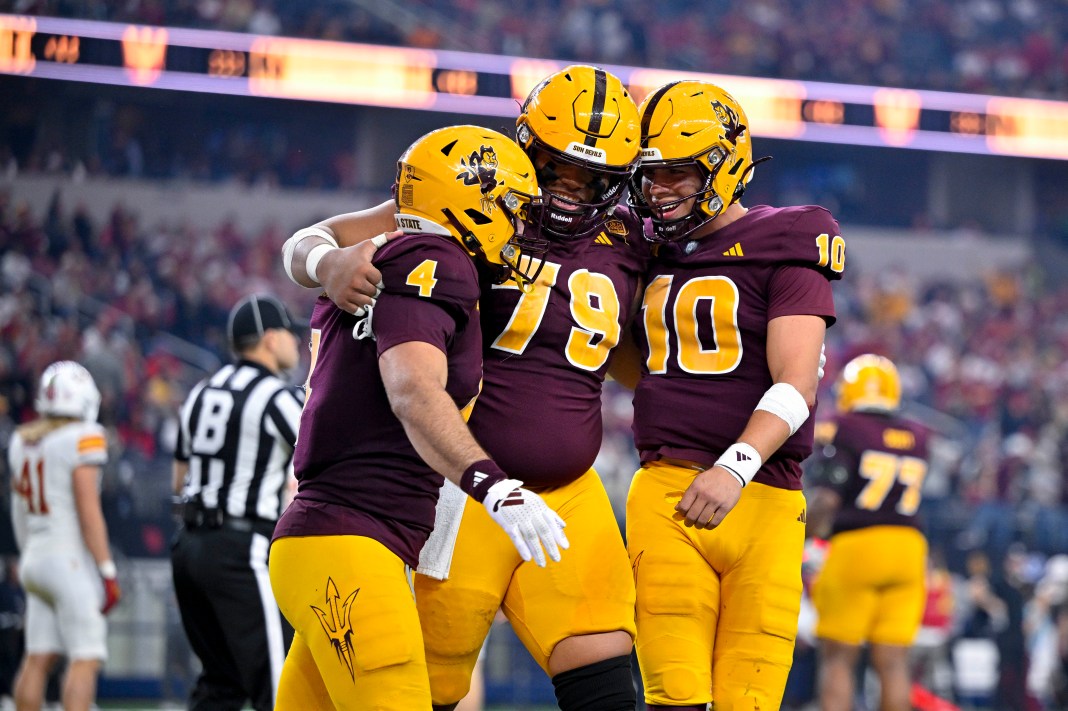 Arizona State Sun Devils running back Cam Skattebo and offensive lineman Leif Fautanu and quarterback Sam Leavitt celebrate