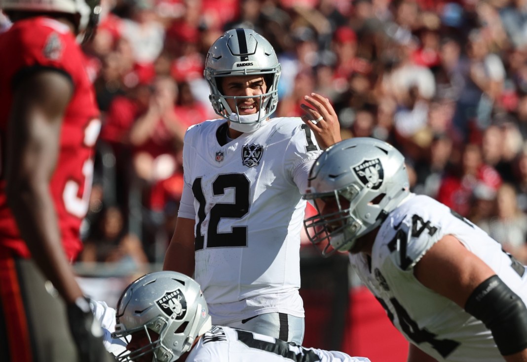 Las Vegas Raiders quarterback Aidan O'Connell signals to his teammates