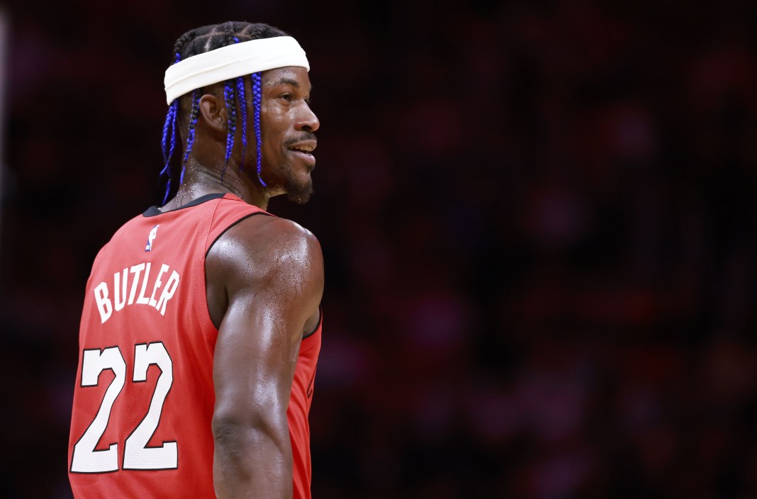 Heat star Jimmy Butler smiles at the bench in a meeting with the Cavaliers during the 2024-25 NBA season.