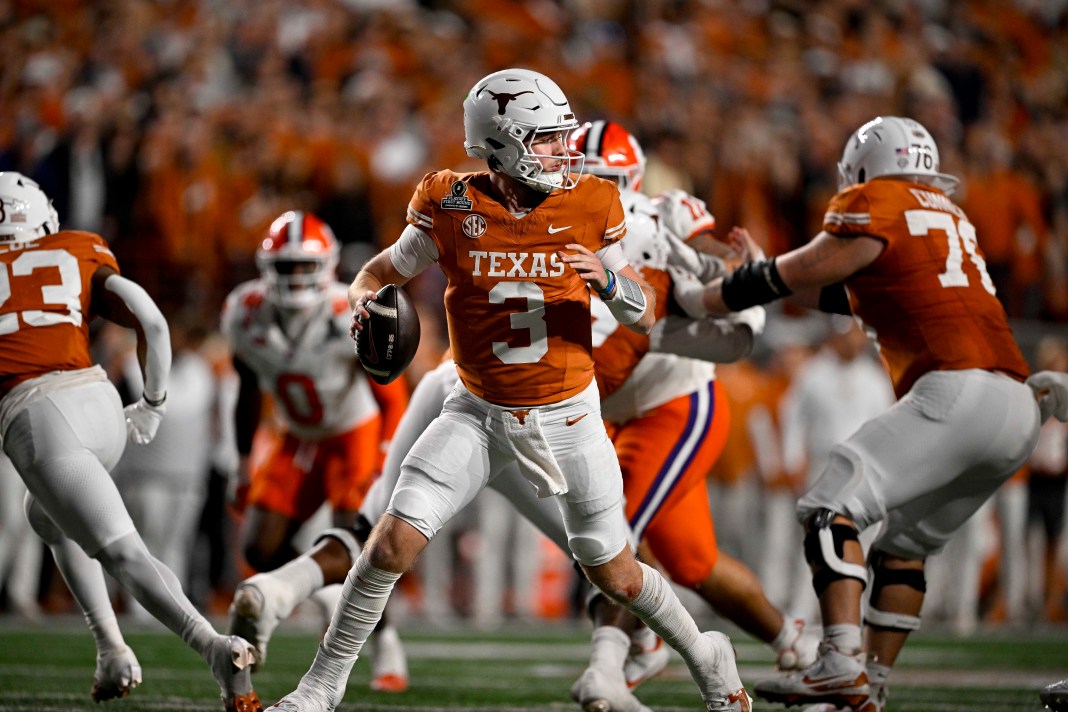 Texas Longhorns quarterback Quinn Ewers (3) prepares to pass while rolling out during the second half of the CFP National Playoff game against Clemson on December 21, 2024, at Darrell K Royal-Texas Memorial Stadium