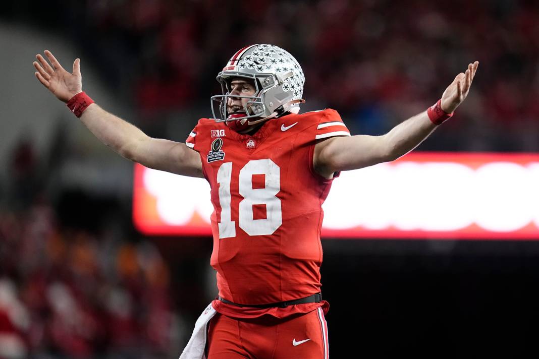 Ohio State quarterback Will Howard (18) celebrates a touchdown by running back TreVeyon Henderson during the second half of the College Football Playoff game against Tennessee on December 22, 2024. Ohio State won 42-17