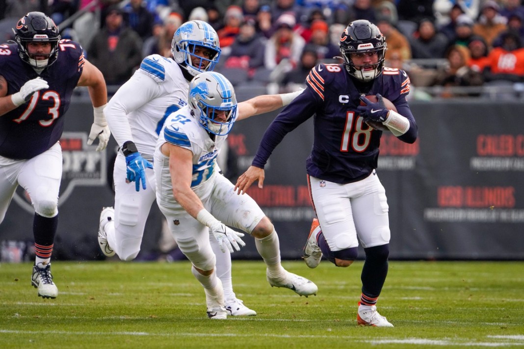 Chicago Bears quarterback Caleb Williams (18) runs with the ball during the game against the Detroit Lions at Soldier Field on December 22, 2024. The Lions won 34-17