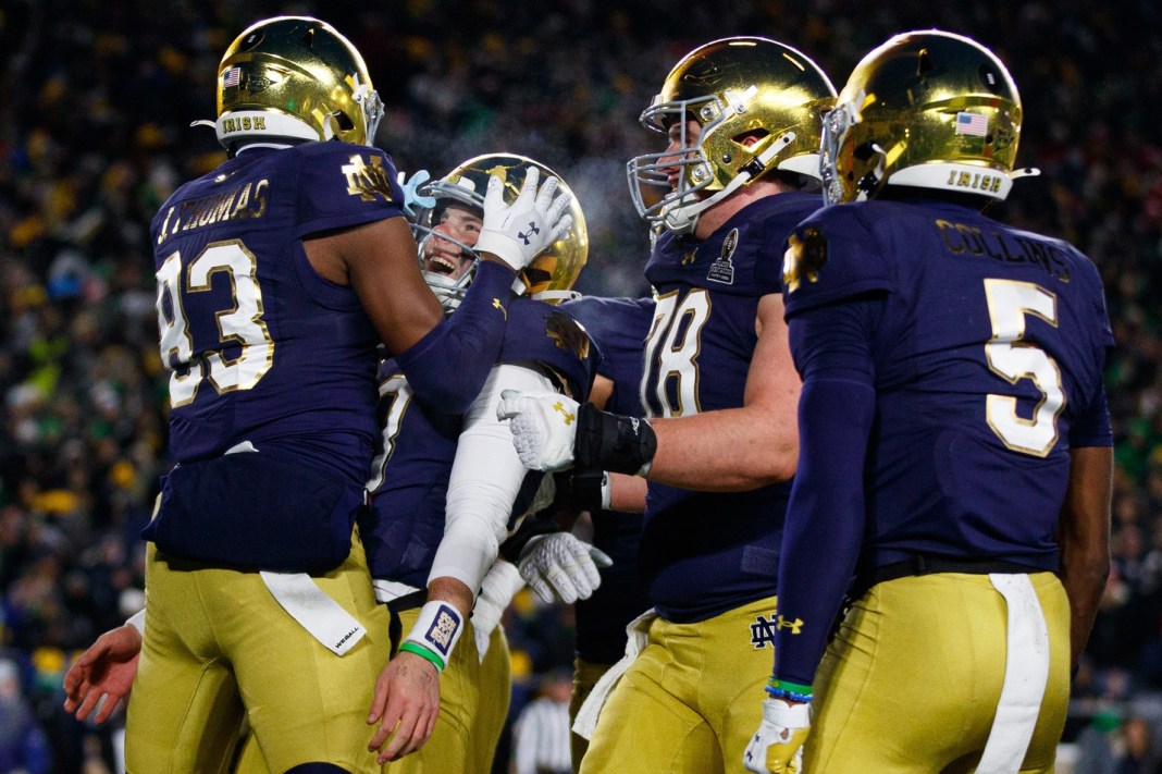 Notre Dame wide receiver Jayden Thomas (83) and quarterback Riley Leonard (13) celebrate after Thomas scores a touchdown during the College Football Playoff first-round game against Indiana on December 20, 2024, in South Bend.