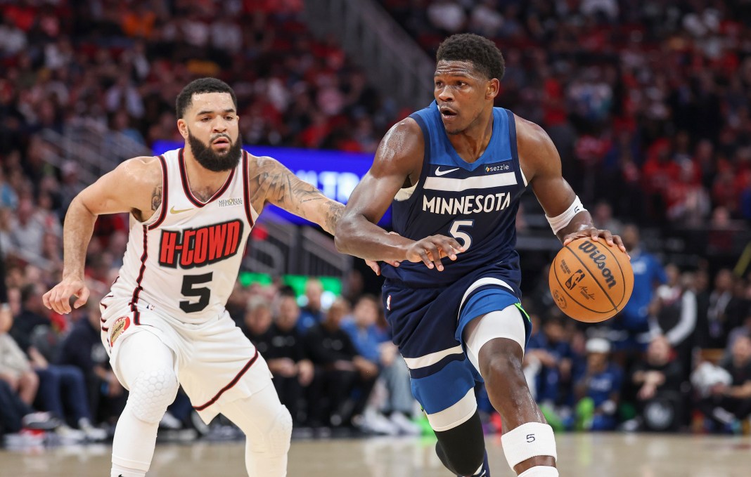 Minnesota Timberwolves guard Anthony Edwards (5) handles the ball while defended by Houston Rockets guard Fred VanVleet (5) during the first quarter at Toyota Center on December 27, 2024.