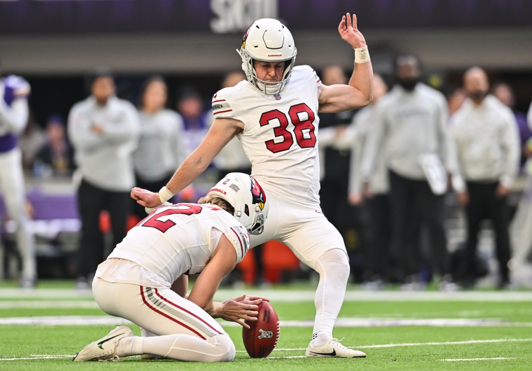 Arizona Cardinals place kicker Chad Ryland kicks a field goal as punter Blake Gillikin holds during the second quarter against the Minnesota Vikings