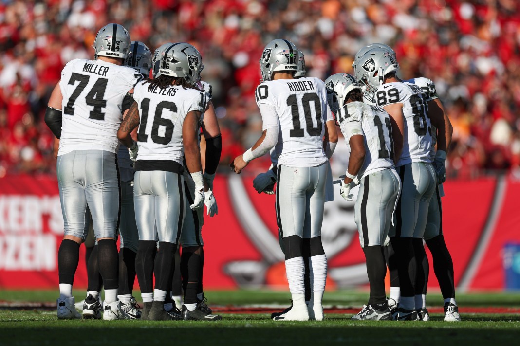 Las Vegas Raiders quarterback Desmond Ridder (10) leads a huddle against the Tampa Bay Buccaneers