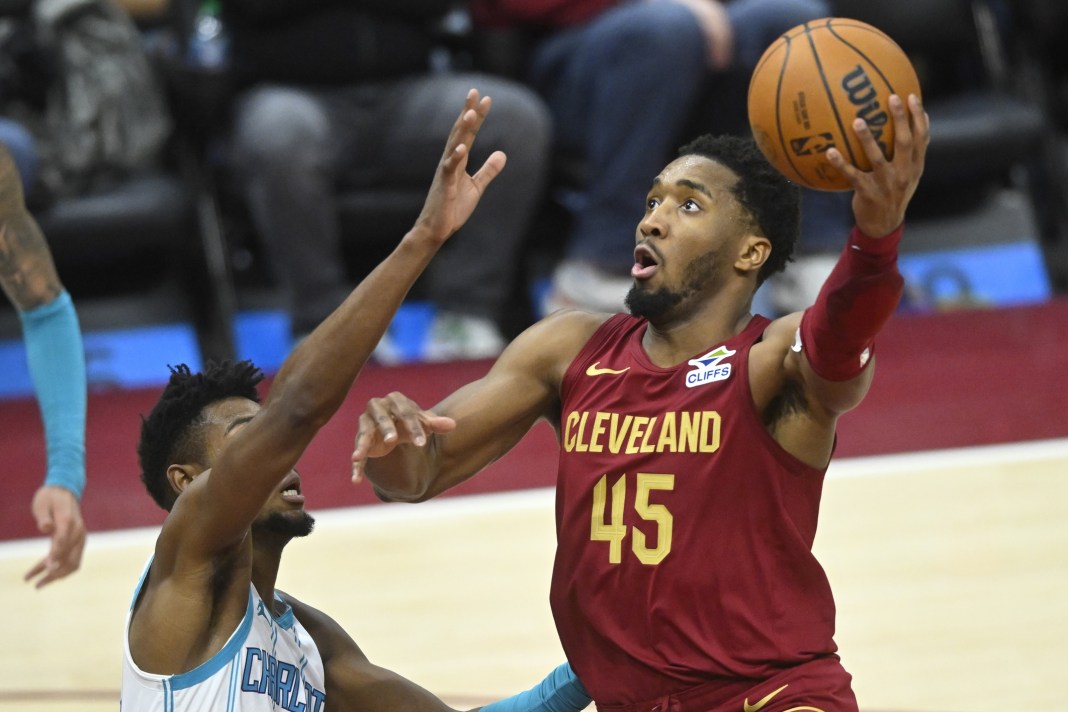 Cleveland Cavaliers guard Donovan Mitchell (45) takes a shot next to Charlotte Hornets forward Brandon Miller (24) during the fourth quarter at Rocket Mortgage FieldHouse on January 5, 2025