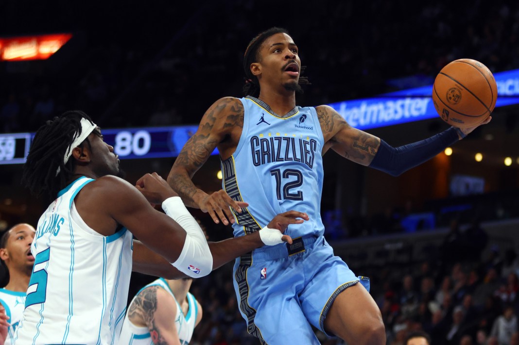 Memphis Grizzlies guard Ja Morant (12) drives to the basket while Charlotte Hornets center Mark Williams (5) defends during the third quarter at FedExForum on January 22, 2025