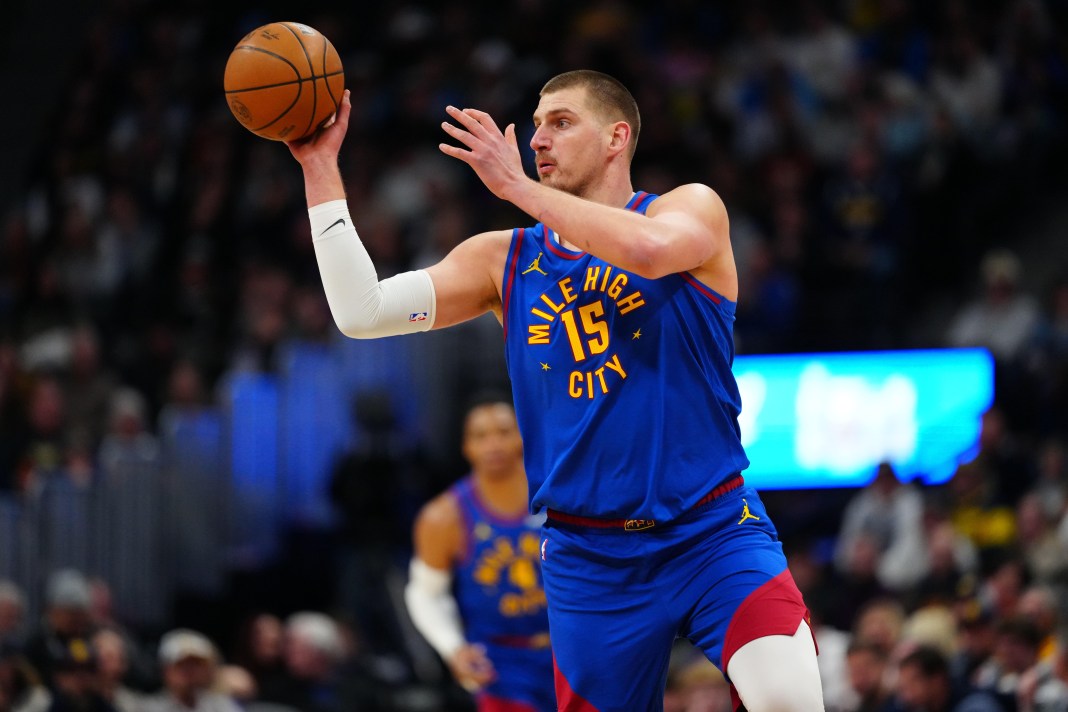 Denver Nuggets center Nikola Jokic (15) passes the ball during the first quarter of the game against the Sacramento Kings at Ball Arena on January 23, 2025