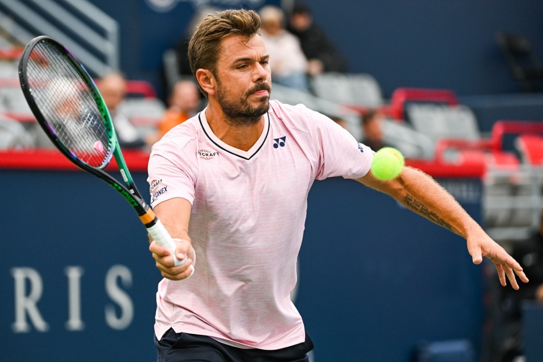 Stan Wawrinka looks to hit a volley against Emil Ruusuvuori.