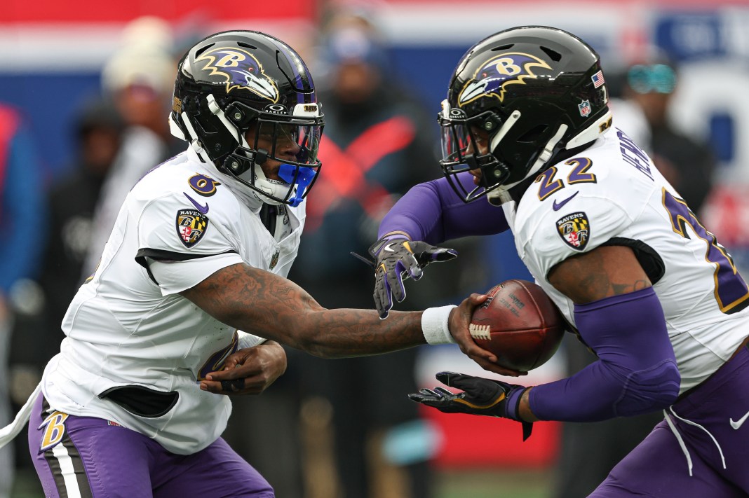 Baltimore Ravens quarterback Lamar Jackson (8) hands off to running back Derrick Henry (22) during the first quarter at MetLife Stadium on December 15, 2024