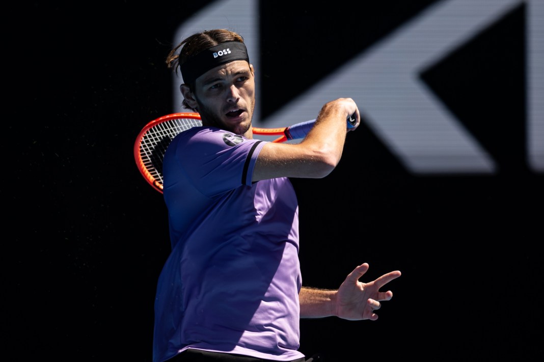 Taylor Fritz follows through with a forehand during the 2025 Australian Open.