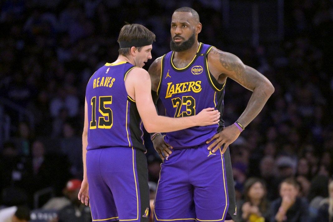 Lakers teammates LeBron James and Austin Reaves talk during a game against the Nets in the 2024-25 NBA season.