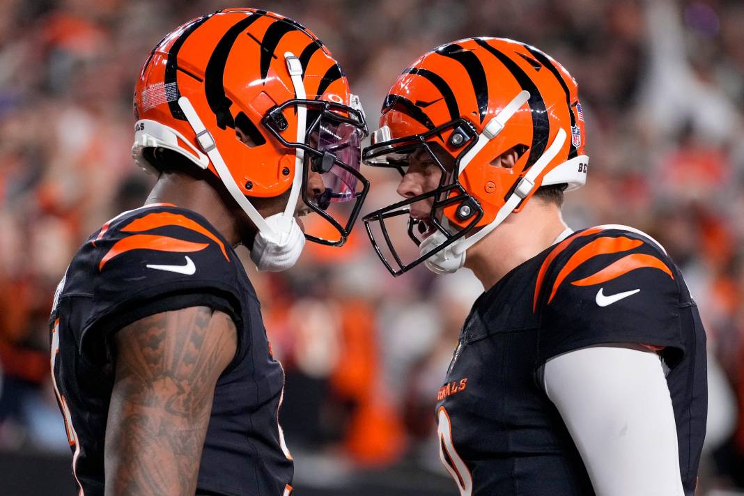 Bengals wide receiver Tee Higgins (5) and quarterback Joe Burrow (9) celebrate a fourth-quarter touchdown against the Broncos at Paycor Stadium on December 28, 2024.