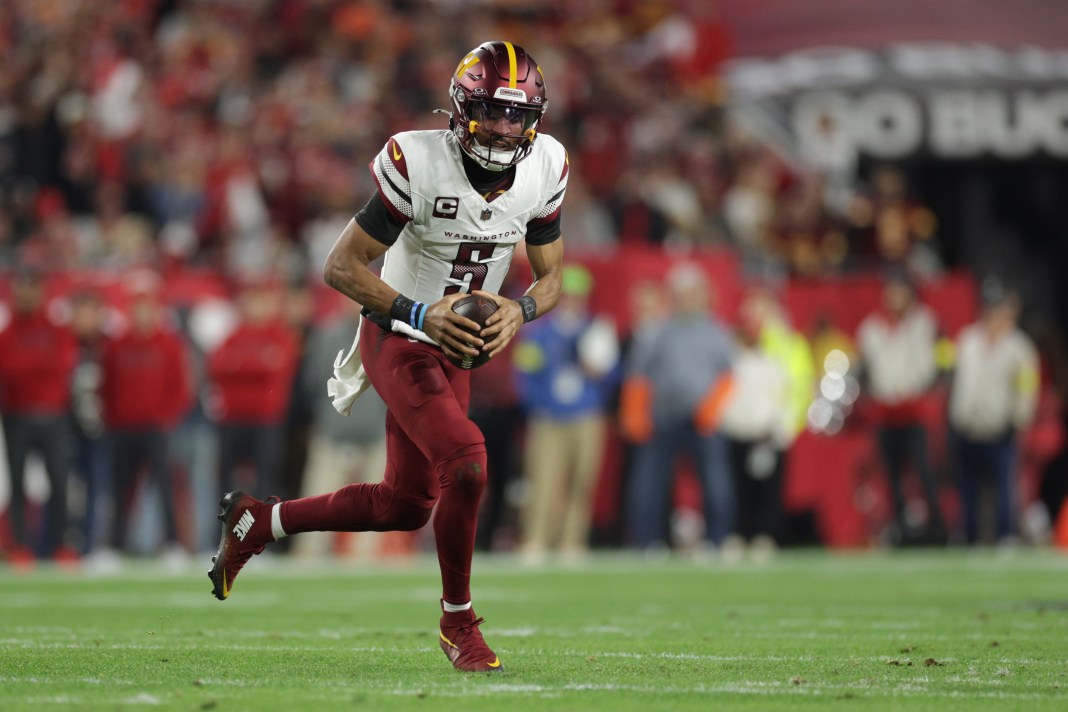 Washington Commanders quarterback Jayden Daniels (5) scrambles during the first quarter of the NFC wild card playoff against the Tampa Bay Buccaneers at Raymond James Stadium on January 12, 2025