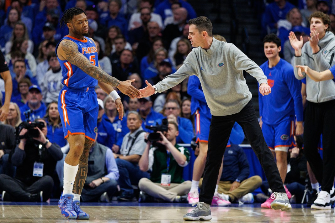 Florida Gators head coach Todd Golden high-fives guard Alijah Martin (15) during the first half of the game against the Kentucky Wildcats at Rupp Arena on January 4, 2025.