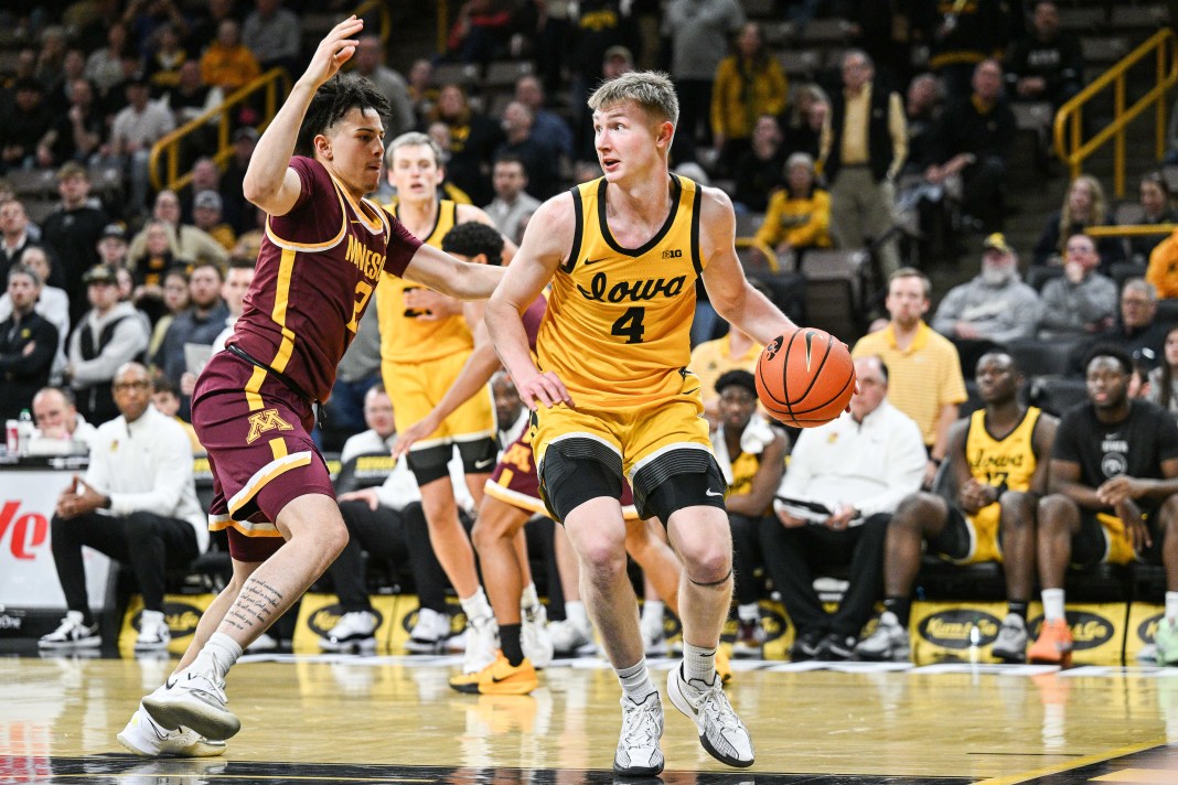 Iowa Hawkeyes guard Josh Dix (4) is defended by Minnesota Golden Gophers guard Mike Mitchell Jr. (2) during the second half at Carver-Hawkeye Arena on January 21, 2025