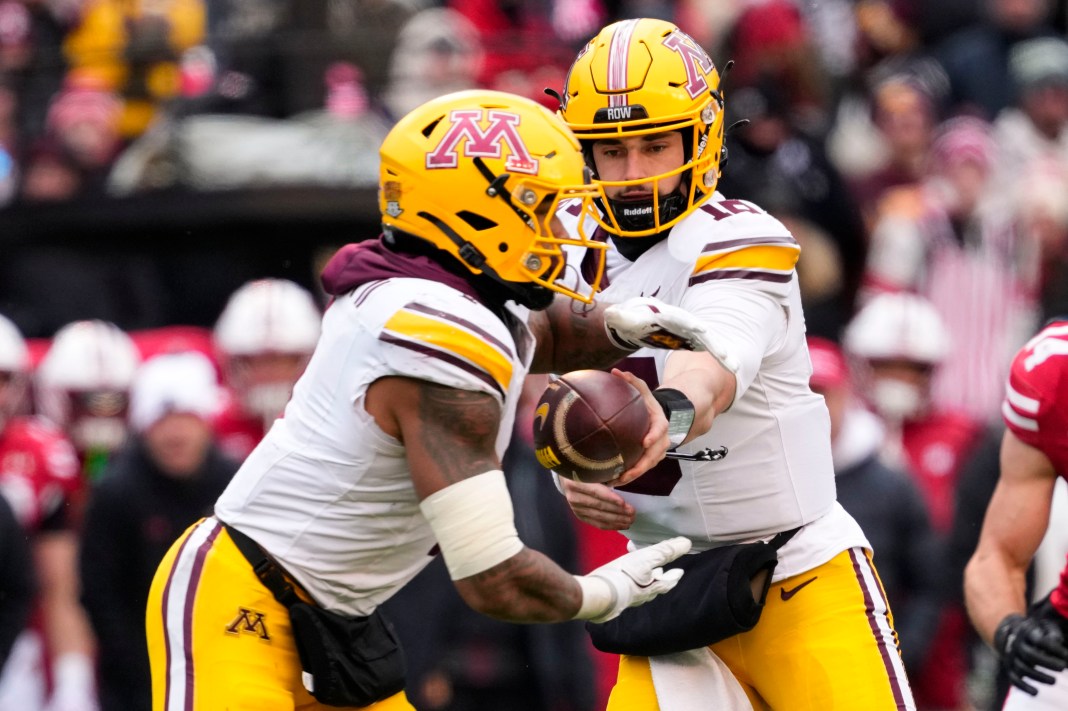 Minnesota Golden Gophers quarterback Max Brosmer (16) hands off the football to running back Darius Taylor (1) during the third quarter against the Wisconsin Badgers at Camp Randall Stadium on November 29, 2024