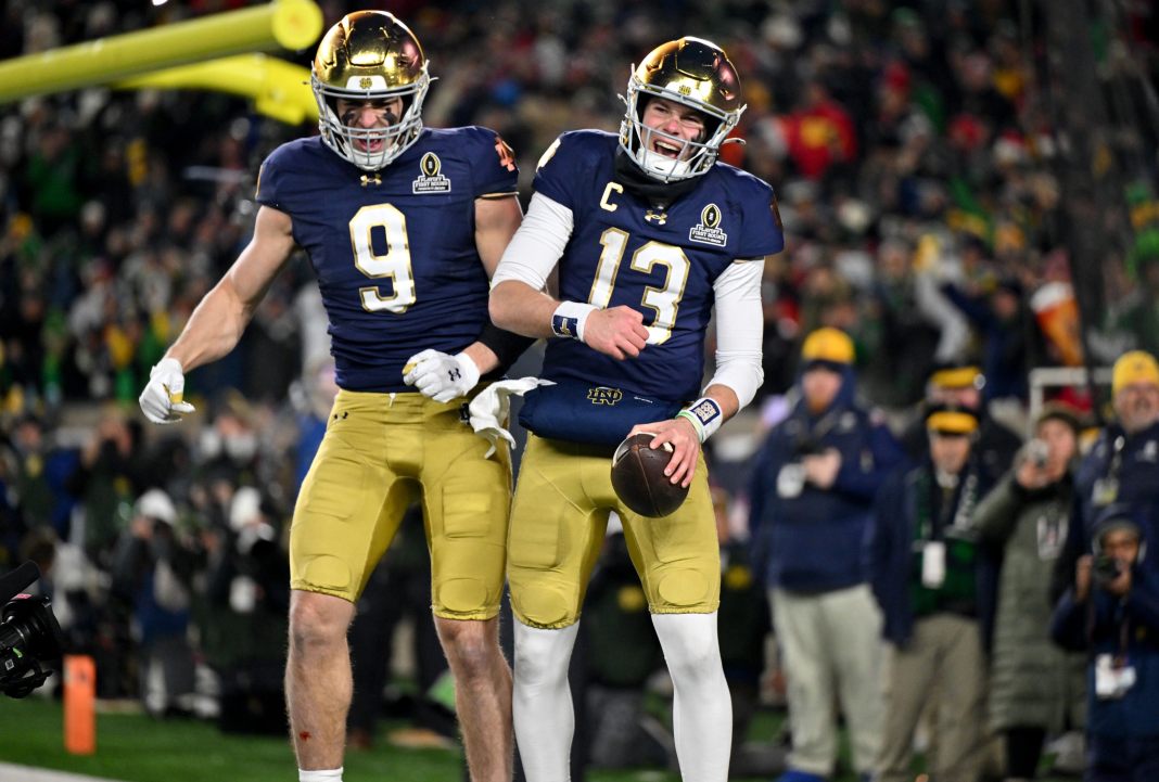 Notre Dame quarterback Riley Leonard (13) celebrates with tight end Eli Raridon (9) after scoring a touchdown during the second half against the Indiana Hoosiers at Notre Dame Stadium on December 20, 2024