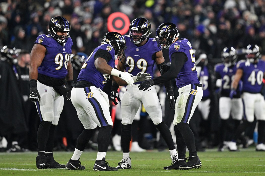 Baltimore Ravens defensive tackle Nnamdi Madubuike (92) celebrates with linebacker Kyle Van Noy (53) and linebacker Odafe Oweh (99) after a tackle against the Pittsburgh Steelers during the third quarter of the AFC wild card game at M&T Bank Stadium on January 11, 2025