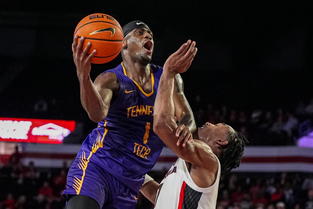 Tennessee Tech Golden Eagles guard Mekhi Cameron (1) attempts to score over Georgia Bulldogs guard Tyrin Lawrence (7) at Stegeman Coliseum on November 4, 2024