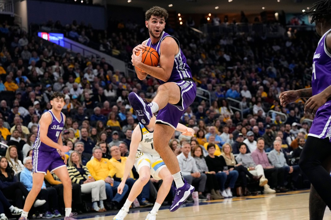 St. Thomas (MN) Tommies guard Ben Nau (2) grabs a rebound during the second half against the Marquette Golden Eagles at Fiserv Forum on December 14, 2023