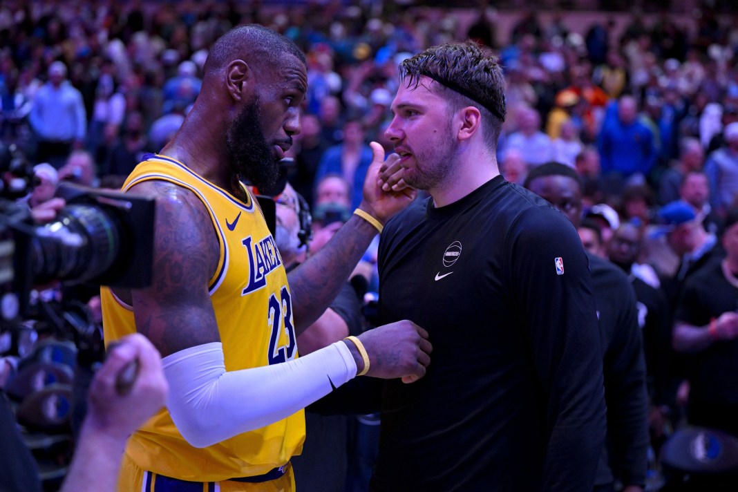 Lakers superstar LeBron James talks to new teammate Luka Doncic during the 2024-25 NBA season.