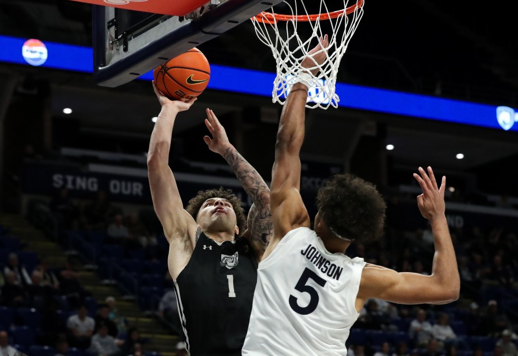 Purdue Fort Wayne Mastodons guard Jalen Jackson (1) shoots the ball while Penn State Nittany Lions guard/forward Puff Johnson (5) defends during the second half at Bryce Jordan Center on November 20, 2024. Penn State defeated Purdue Fort Wayne 102-89.