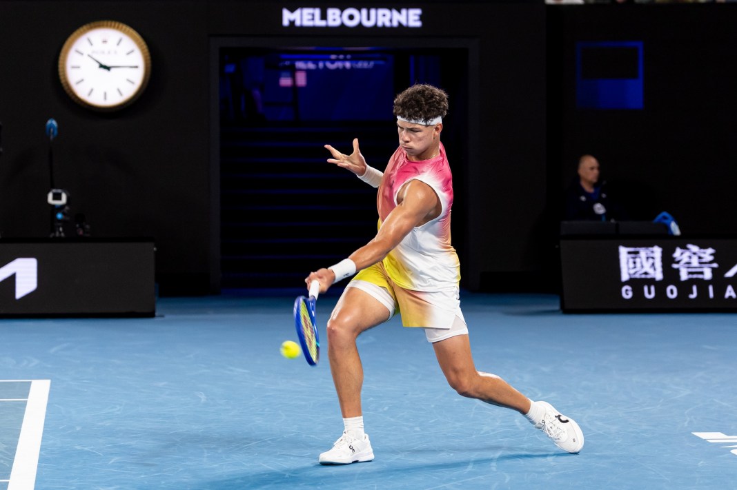 Ben Shelton hits a forehand against Jannik Sinner at the 2025 Australian Open.