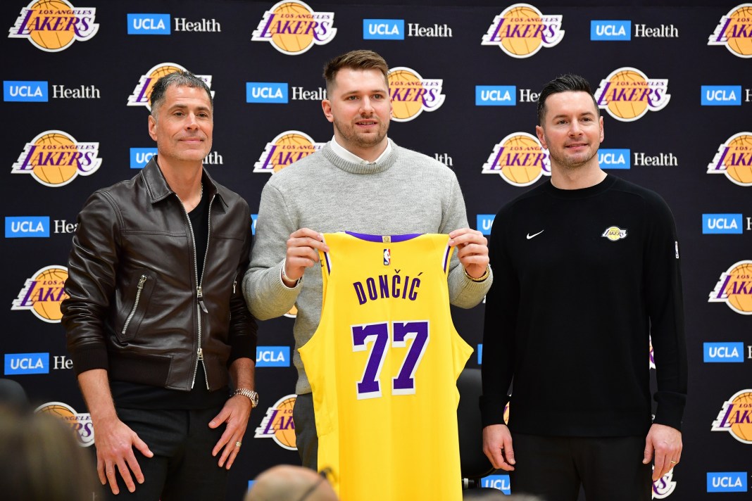 Lakers superstar Luka Doncic poses with his new jersey during the 2024-25 NBA season.