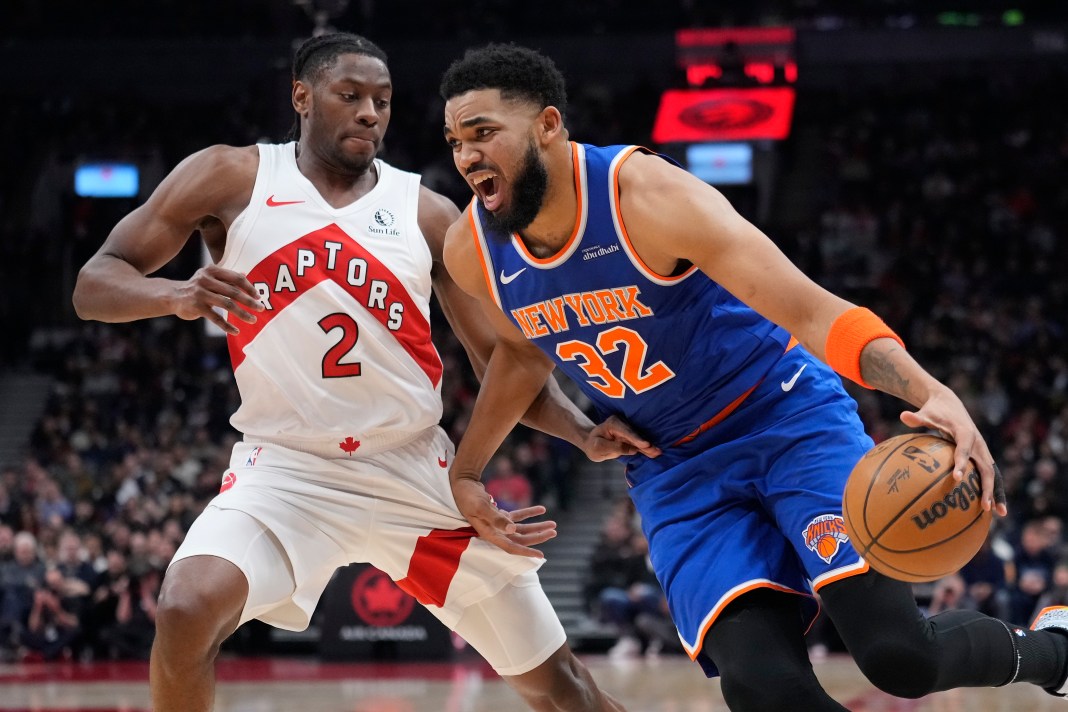 New York Knicks center Karl-Anthony Towns (32) drives to the net against Toronto Raptors forward Jonathon Mogbo (2) during the first half at Scotiabank Arena on February 4, 2025