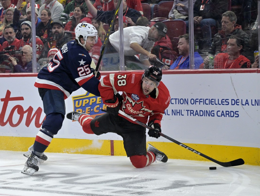 Team Canada forward Brandon Hagel (38) plays the puck while Team United States defenseman Charlie McAvoy (25) defends during the second period of a 4 Nations Face-Off ice hockey game at the Bell Centre on February 15, 2025.