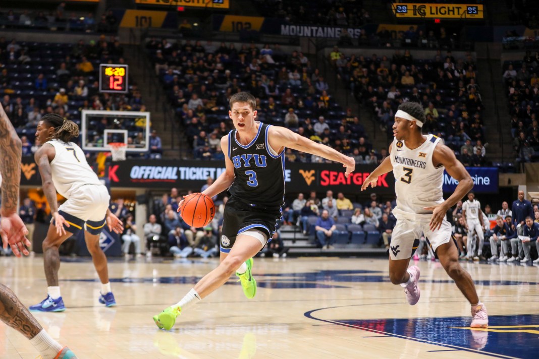 Brigham Young Cougars guard Egor Demin (3) drives down the lane against West Virginia Mountaineers guard KJ Tenner (3) during the second half at WVU Coliseum on February 11, 2025.