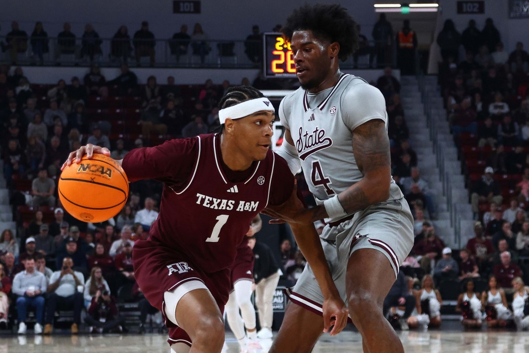 Texas A&M Aggies guard Zhuric Phelps (1) dribbles the ball while Mississippi State Bulldogs forward Cameron Matthews (4) defends during the first half at Humphrey Coliseum on February 18, 2025.